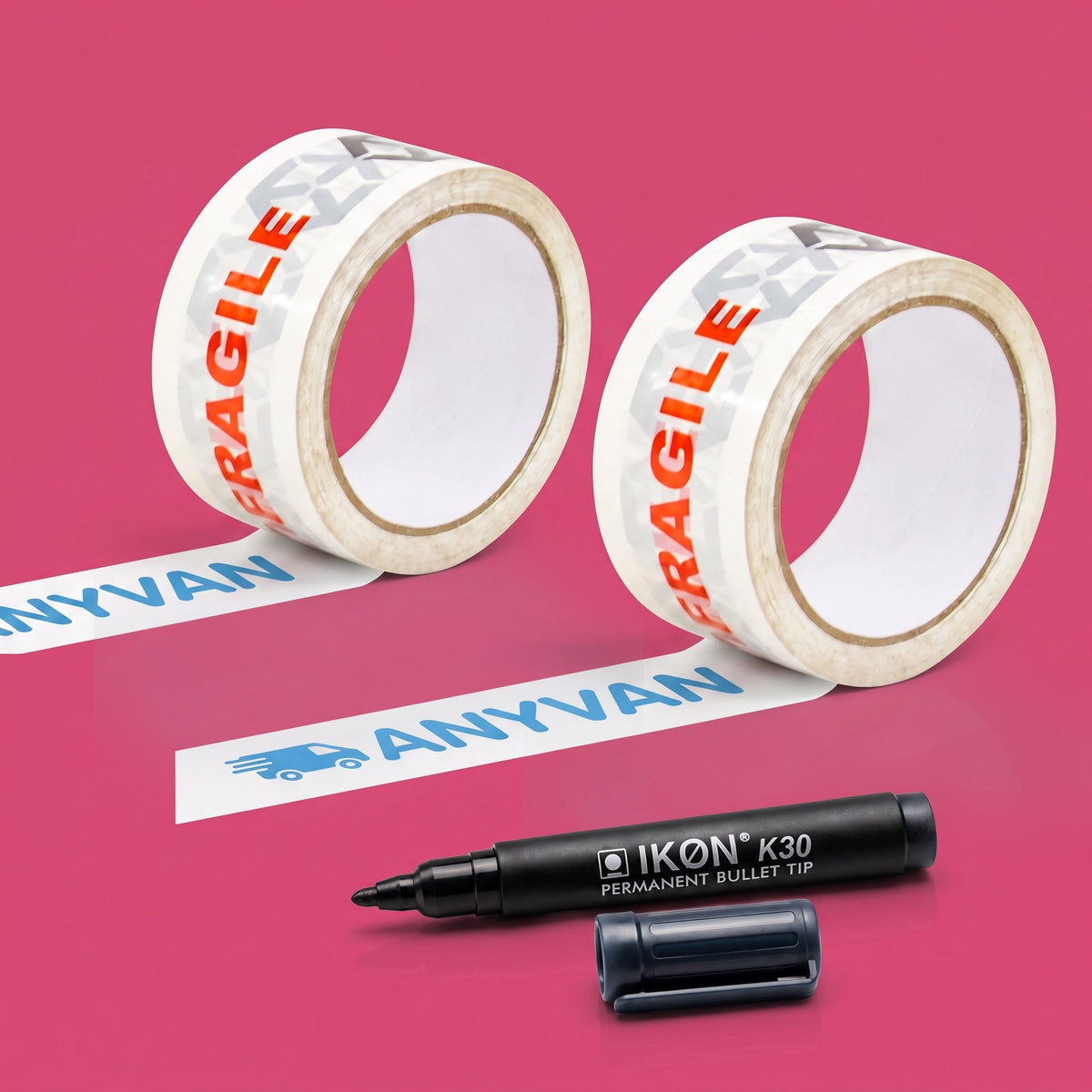 Two rolls of white AnyVan fragile tape and a black Ikon K30 permanent marker, on a pink background