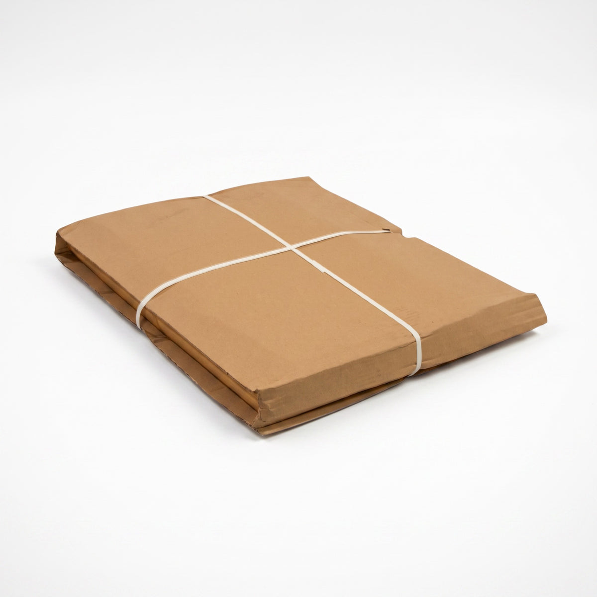 The 250 sheets of white packing paper as delivered: a brown wrapped pack tied with white string, on a white background
