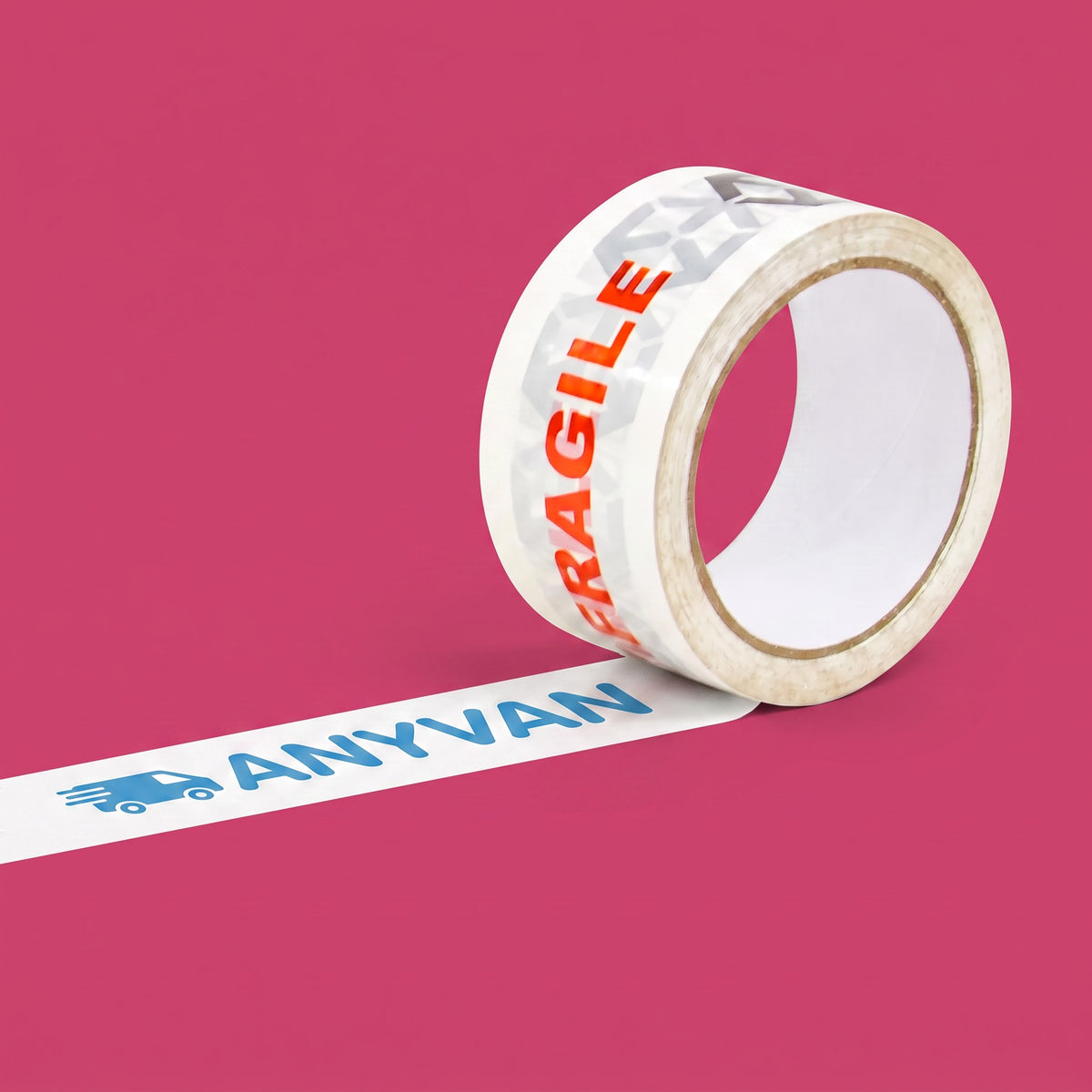 A roll of white shipping tape printed with 'ANYVAN' in blue and a truck icon, with a second section unrolled across a solid pink background. The roll itself is printed with 'FRAGILE' in orange and a gray pattern.