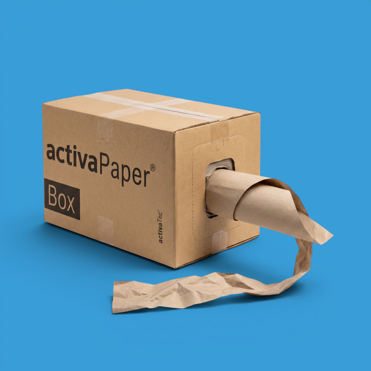 A brown cardboard box with 'activaPaper Box' printed on the side, featuring a paper roll protruding from one end and a loose strip of paper on the surface, set against a solid blue background.