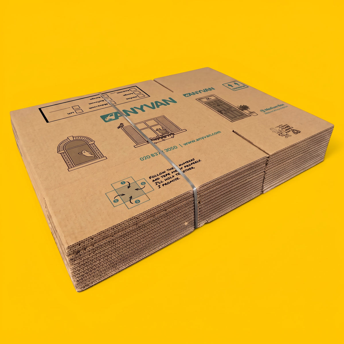 A stack of flat-packed AnyVan large moving boxes strapped together, on a yellow background