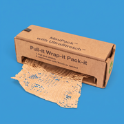 A MiniPack honeycomb paper dispenser box with brown honeycomb paper pulled out of the front, on a blue background