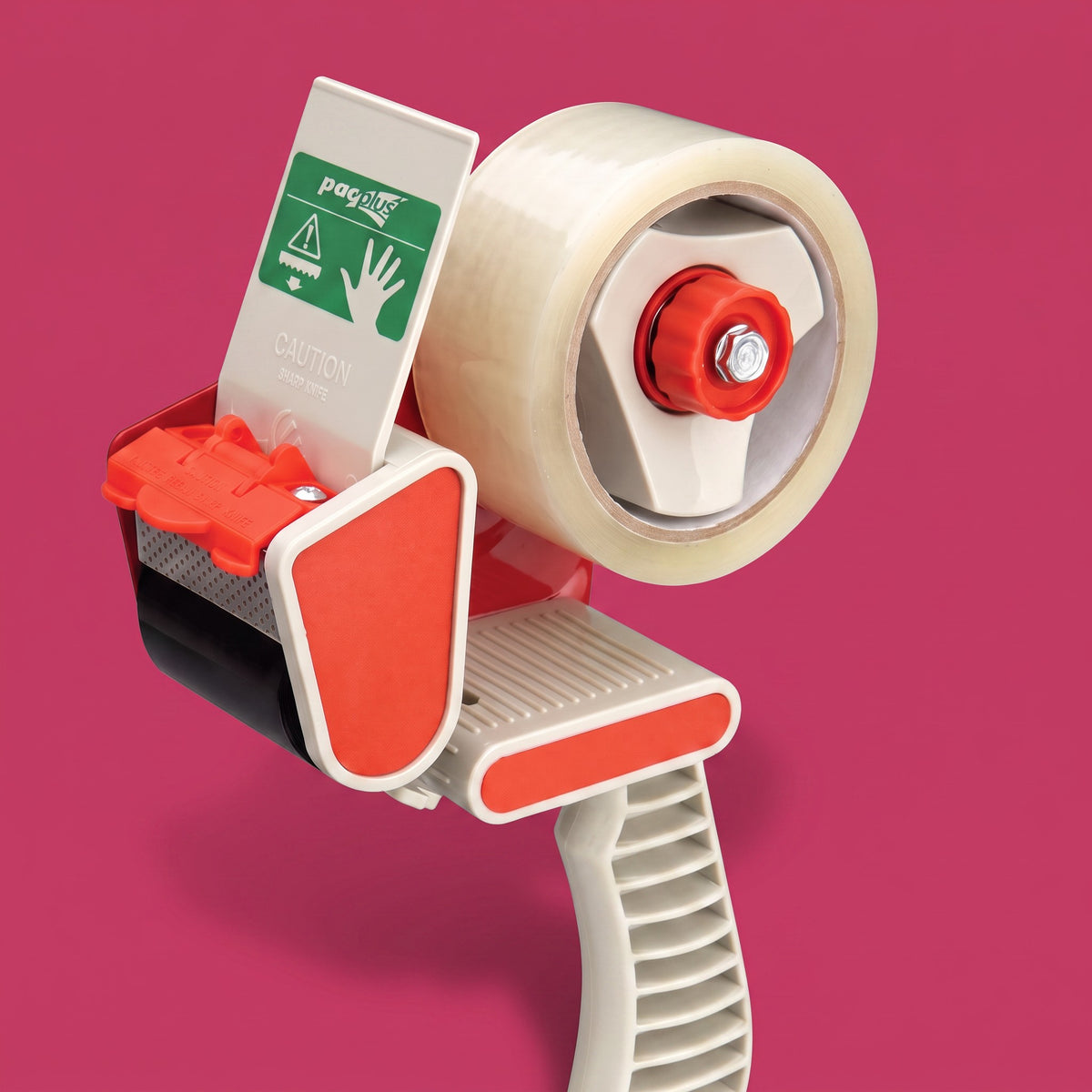 A Positape clear tape dispenser with a large roll of clear tape, orange-red accents, and a white handle, shown against a solid pink background.